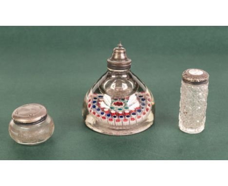 A WHITE METAL TOPPED MILLEFIORI GLASS PAPERWEIGHT CUM INKWELL, also two silver topped dressing table jars (3) 