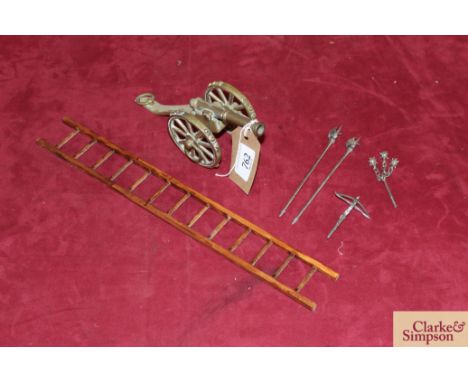 A quantity of dolls house items for a fort or castle including a ladder, brass cannon, crossbow and other weapons (6 pieces)