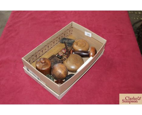 A box of assorted treen including bowling ball and cheeses, snuff box, native American tobacco pipe, an "Anri" carved figural