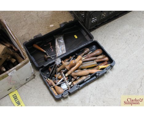A box of various chisels and other wood working tools 