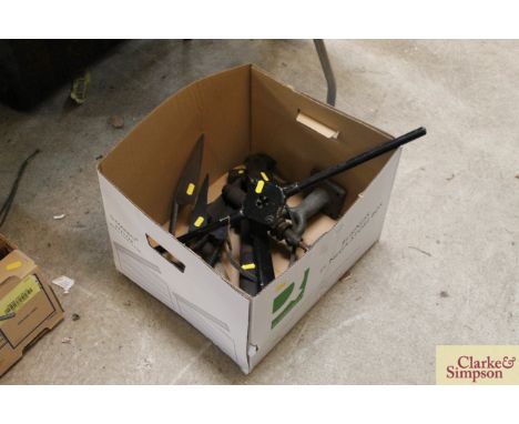 A box containing numerous tools including large adjustable spanners, grinding wheel, thread cutter, shears etc.