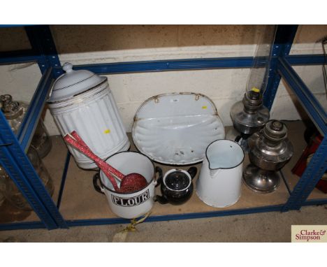 A quantity of enamel kitchenalia; two oil lamps etc.
