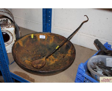 A cast iron bowl and ladle
