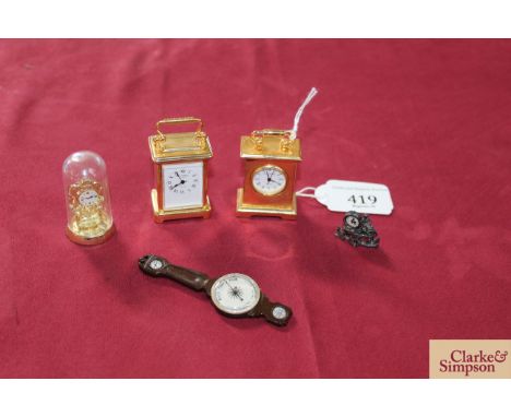 Two miniature brass cased carriage style clocks; a miniature barometer; miniature anniversary clock and a miniature mantel cl