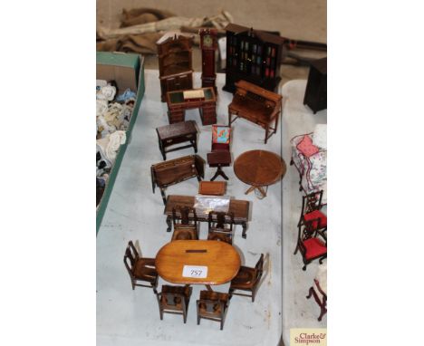 A quantity of dolls house furniture to include oval table and six chairs, serving table, circular pedestal table, pedestal de