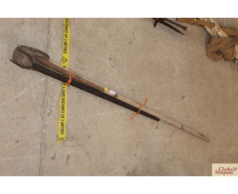 A long handled spade and a small two pronged fork 
