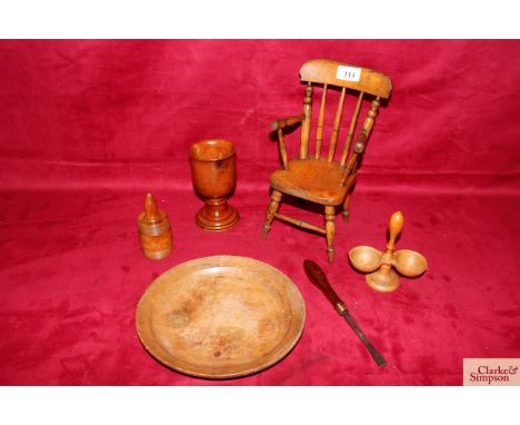A group of various treen items comprising an antique miniature elbow chair, a sycamore platter, a goblet, a boxwood powderer,