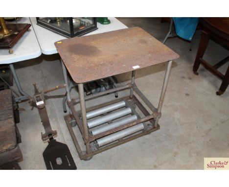 An iron workshop two tier table with integral roller 