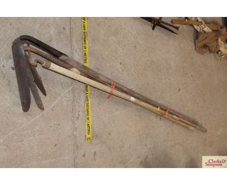 Three drainage scoops and a pipe positioning iron 