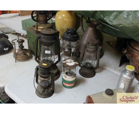 Three various Hurricane lamps, a Tilley lamp and a Paraffin lamp