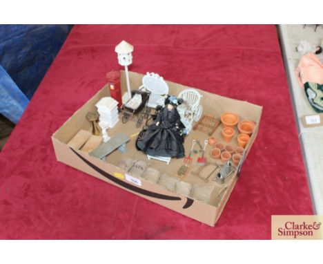A quantity of dolls house garden items to include flower pots, spade and fork, various bags of compost, potatoes, garden benc