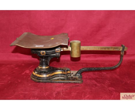 A set of W T Avery cast iron and brass counter scales, with copper tray and brass sliding counter weight