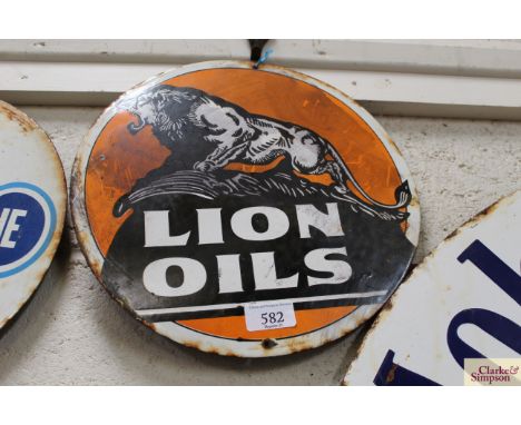A circular enamel advertising sign for "Lion Oils", 12" dia.