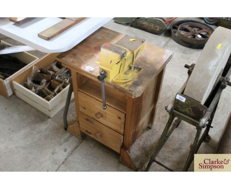 A pine nest of drawers with attached bench vice 