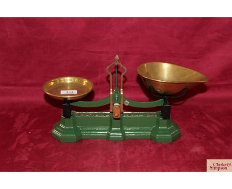 A set of cast iron and brass W T Avery Ltd counter scales to weigh 2lbs with brass weight tray and brass scoop
