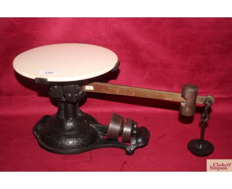 A set of cast iron and brass counter scales with ceramic platform