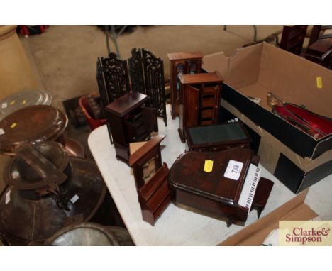 A quantity of dolls house furniture to include pedestal desk, piano and stool, folding pierced wooden screen, etc. (9 pieces)