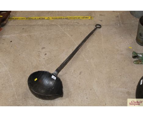 A large iron ladle possibly for pitch or lead
