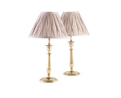 PAIR OF FRENCH BRASS CANDLESTICK LAMPS 19TH CENTURY with urn form candle nozzles on hexagonal tapered columns ending in paw f