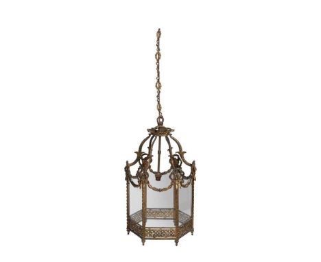 GEORGIAN STYLE GILT METAL HALL LANTERN 20TH CENTURY the hexagonal glazed paned sides in a cast ribbon tied frame hung with ga