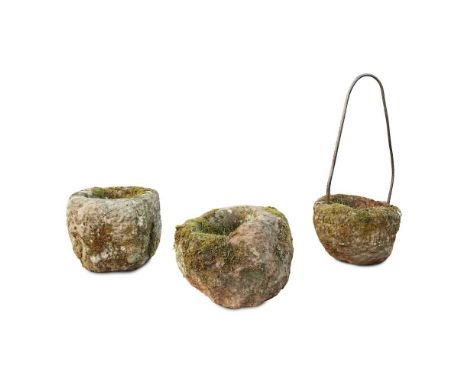 THREE STONE TROUGHS LATE 18TH / EARLY 19TH CENTURY of rough carved boulder form with hollowed centres, one set with a later l