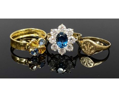 THREE GOLD RINGS, comprising a continental wide band ring with colourful stone four-leaf clover mount, stamped 750, 2gms, mid