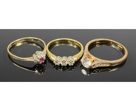 THREE VINTAGE DRESS RINGS comprising two gold and one plated, the first stamped 750, 3 claw mounted diamonds, 7 tiny diamonds