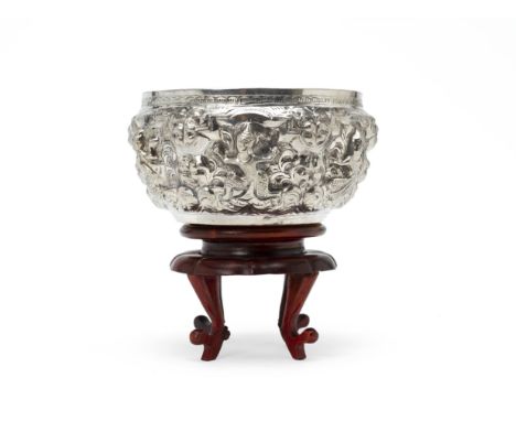 A THAI SILVER PRESENTATION BOWL
Circa 1960, repousse decorated with figures, the interior with presentation inscription for t