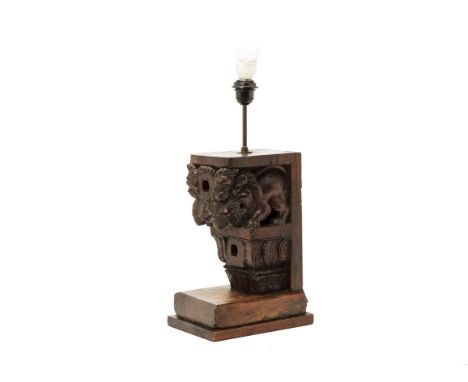 A CARVED WOOD CORBEL TABLE LAMP
Carved mythical beasts and foliage, on later wood stand
50cm high (lamp stand)
Condition: Con