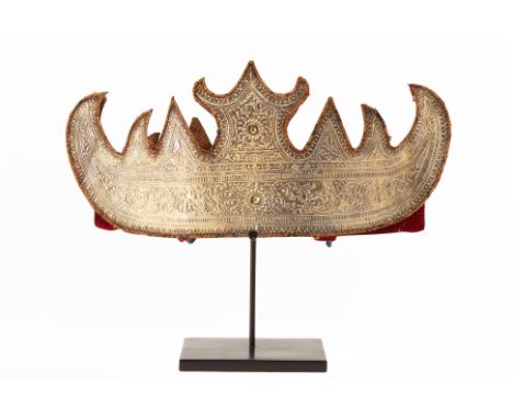 A SUMATRA CHIEF'S CROWN
Embossed metal exterior decorated with foliate details with a red fabric lined interior on a square m