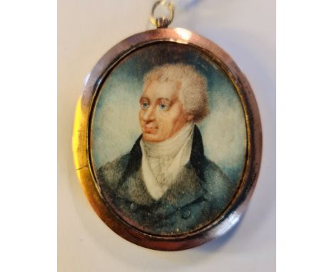 A Georgian portrait miniature on ivory a gentleman in gilt metal oval frame and plaited hair locket with metal initials to ba