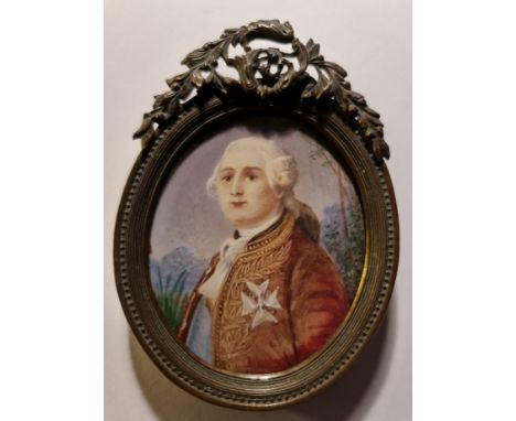 A 19th century portrait miniature on ivory of a Georgian gentleman with white hair and cross to breast of dress coat with lan