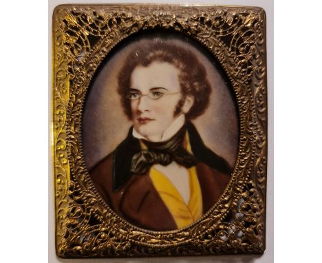 A late 19th century portrait miniature on ivory of a gentleman with glasses in a pierced gilt metal frame. This item has been