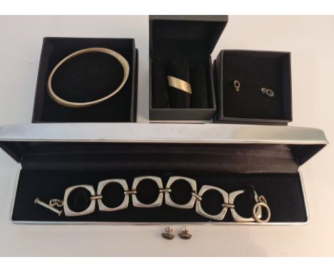 A metal necklace and a pair of stud earrings, along with bangle and ring