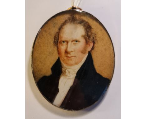 A Georgian portrait miniature on ivory of a gentleman in black jacket in gold oval frame - unmarked. This item has been regis