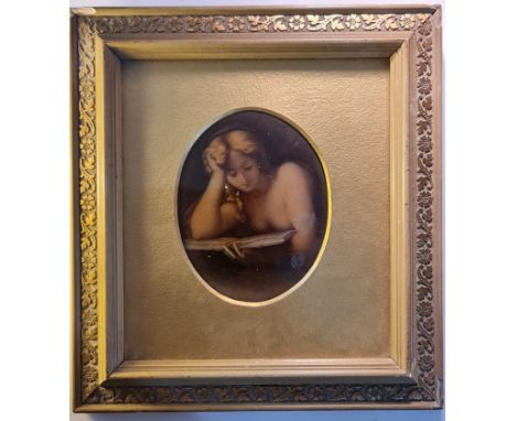 A late 19th century/early 20th century crystoleum portrait of lady reading a book in gilt oval mount in frame.