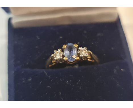 An 18ct hallmarked yellow gold sapphire and diamond three stone ring, approx. total diamond carat weight 0.20cts, ring size L