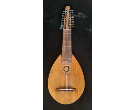 A Lute guitar flat backed model with seven courses plus five lower strings sixteen strings in total labelled and signed in in