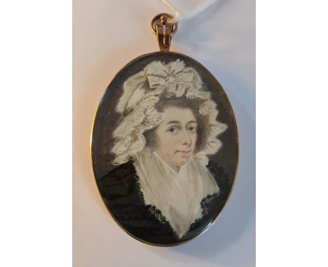 A 19th century portrait miniature on ivory of a Georgian lady with white lace headdress and black dress in gilt metal oval se