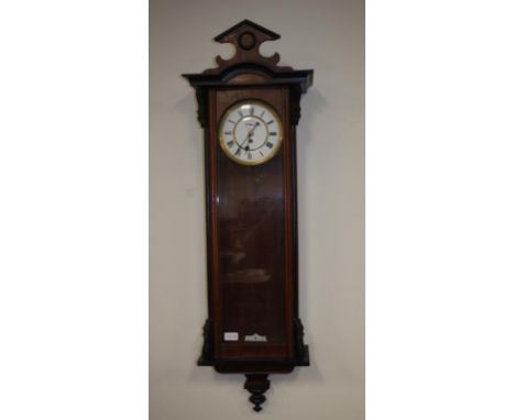 Vintage single weight Vienna regulator clock Roman numerals on enamel dial. Wood cased with carved pediment. Winder, weight &