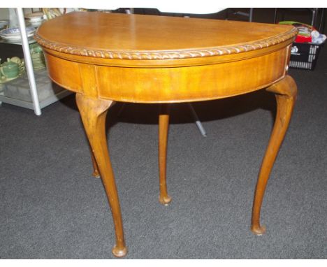 Maple card table demi-lune shape which expands to circular baize covered playing surface. Cabriole legs with additional leg t