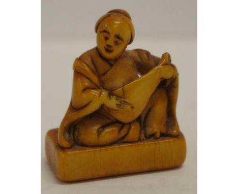 Antique Japanese carved netsuke of a seated woman playing a musical instrument. H4cms approx.