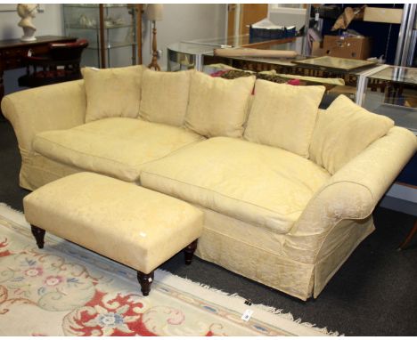 An early 20th century three seater Chesterfield style sofa upholstered in yellow material with matching footstool