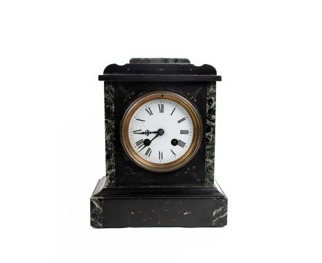 An early 20th century slate mantle clock with marble accents and 8 day movement. 