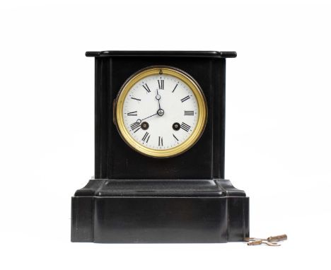 A black slate mantle clock by T. Hutchings. White enamel face with roman numeral markers and 8 day movement. 