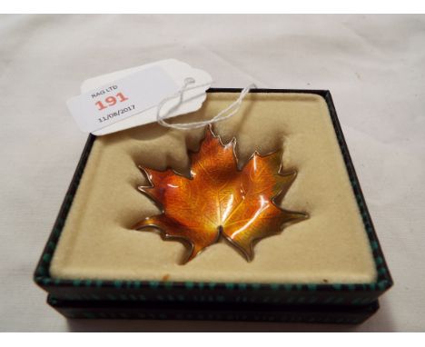 A mid-20thC Norwegian gilded silver and enamel leaf brooch, boxed, marked to the back with maker's mark for Hroar Prydz