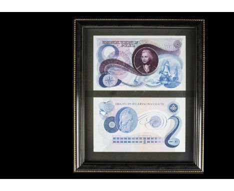 A Framed pair of Bradbury Wilkinson advertising banknotes, along with a collection of design essays, plate proofs, photograph