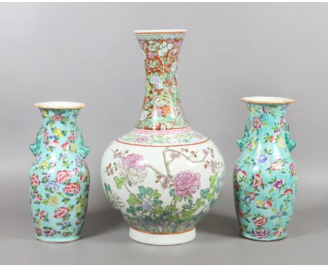 A Chinese famille rose bottle vase and two mantel vases after Qianlong originals turquoise ground and decorated with flowers,
