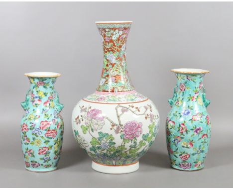 A Chinese famille rose bottle vase and two mantel vases after Qianlong originals turquoise ground and decorated with flowers,