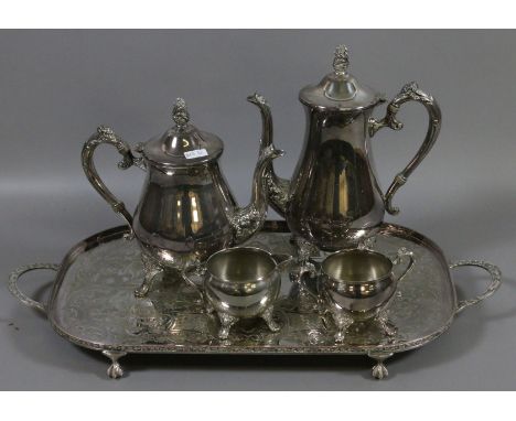 A silver plate four part tea service on twin handled serving tray.